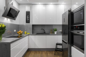 Beautifully designed kitchen in white and grey with steel elements